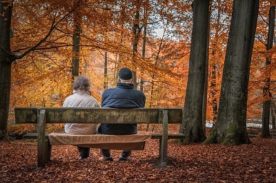 Couple sitting on a bench in Autumn