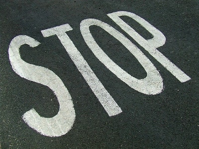 Stop message painted on road